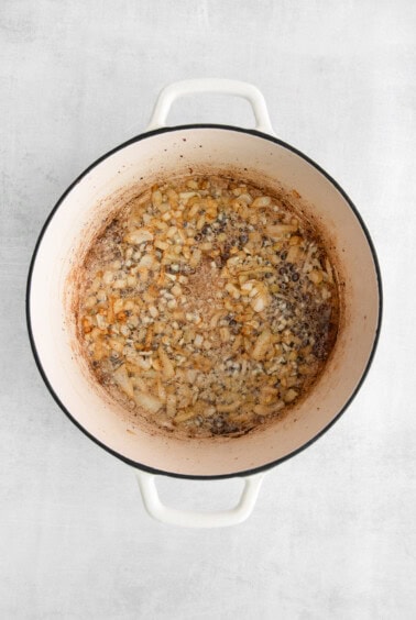 a pot filled with beans on a white background.