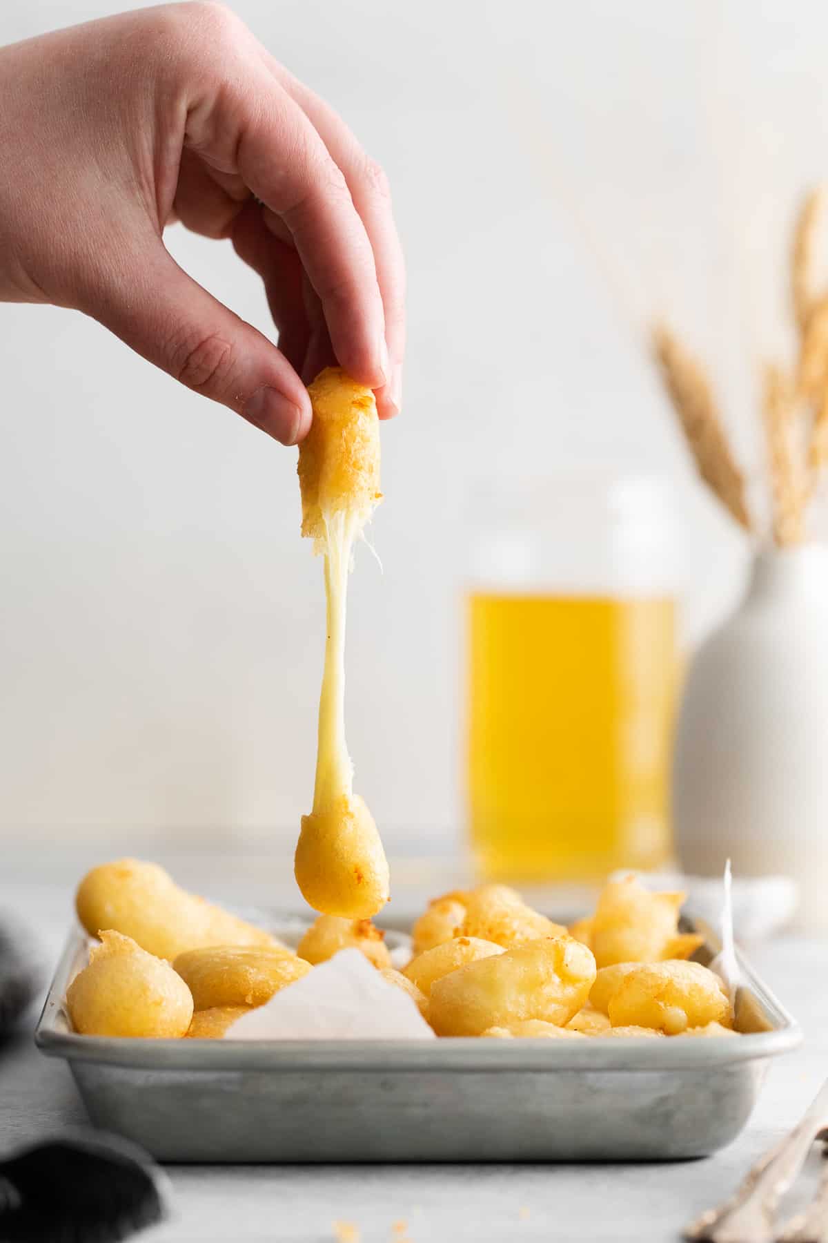 hand holding cheese curd.