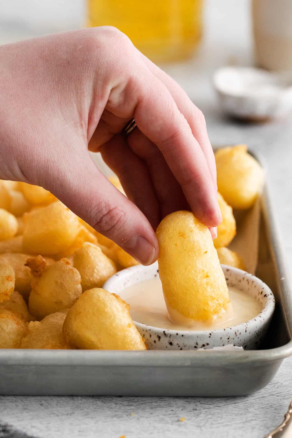 dipping cheese curds in aoli.