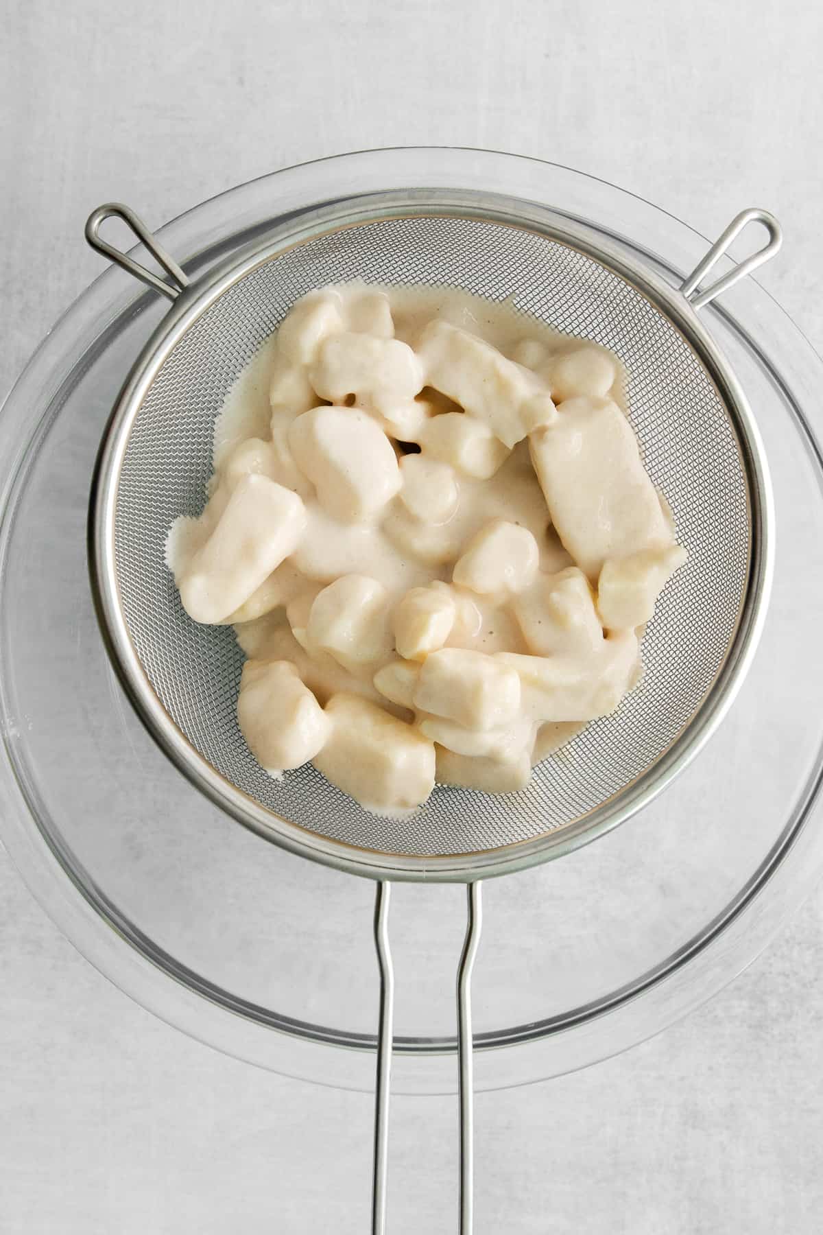 batter covered curds in strainer.