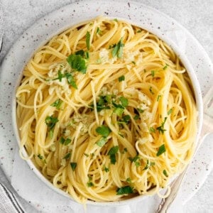 A plate of pasta tossed with garlic butter sauce.