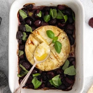 a dish with olives, tomatoes and bread.