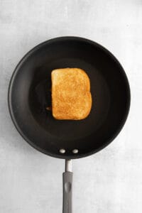 a toasted piece of bread in a frying pan.