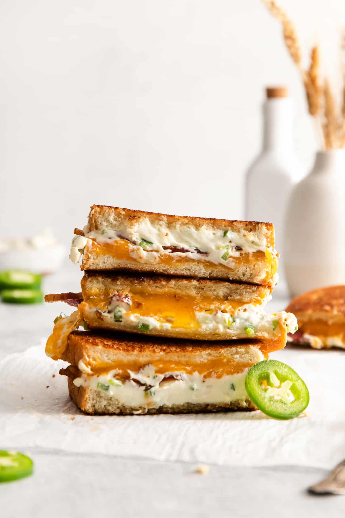 Jalapeno popper grilled cheese stacked on top of each other.