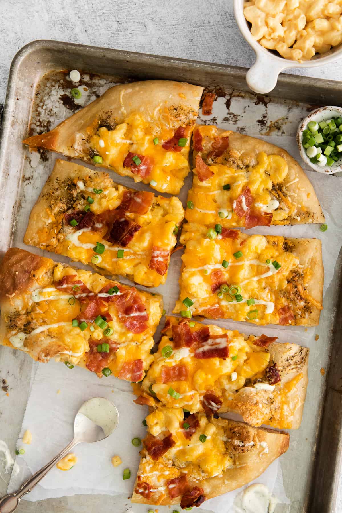 mac and cheese pizza on baking sheet.