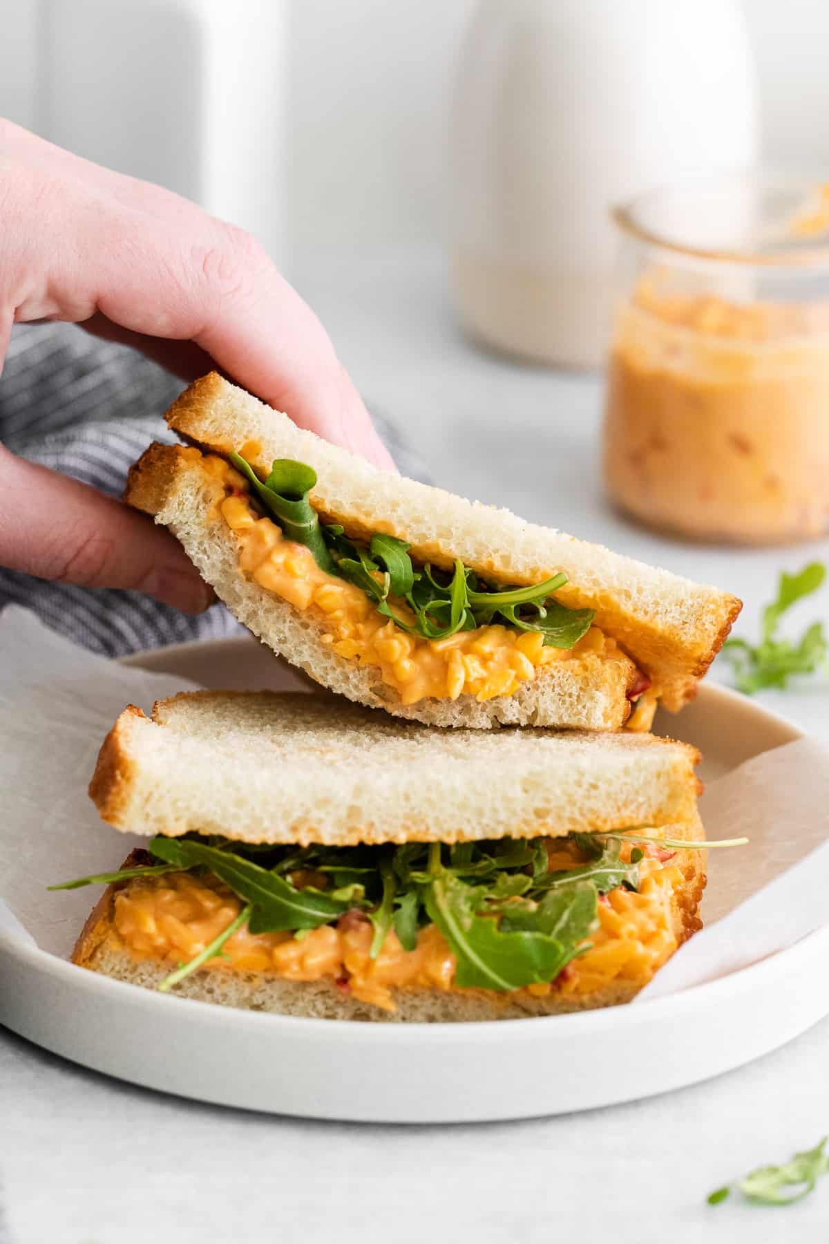 A pimento cheese sandwich with arugula. 