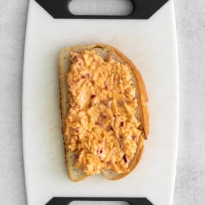 A slice of bread with pimento cheese spread.