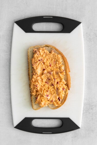 A slice of bread with pimento cheese spread.