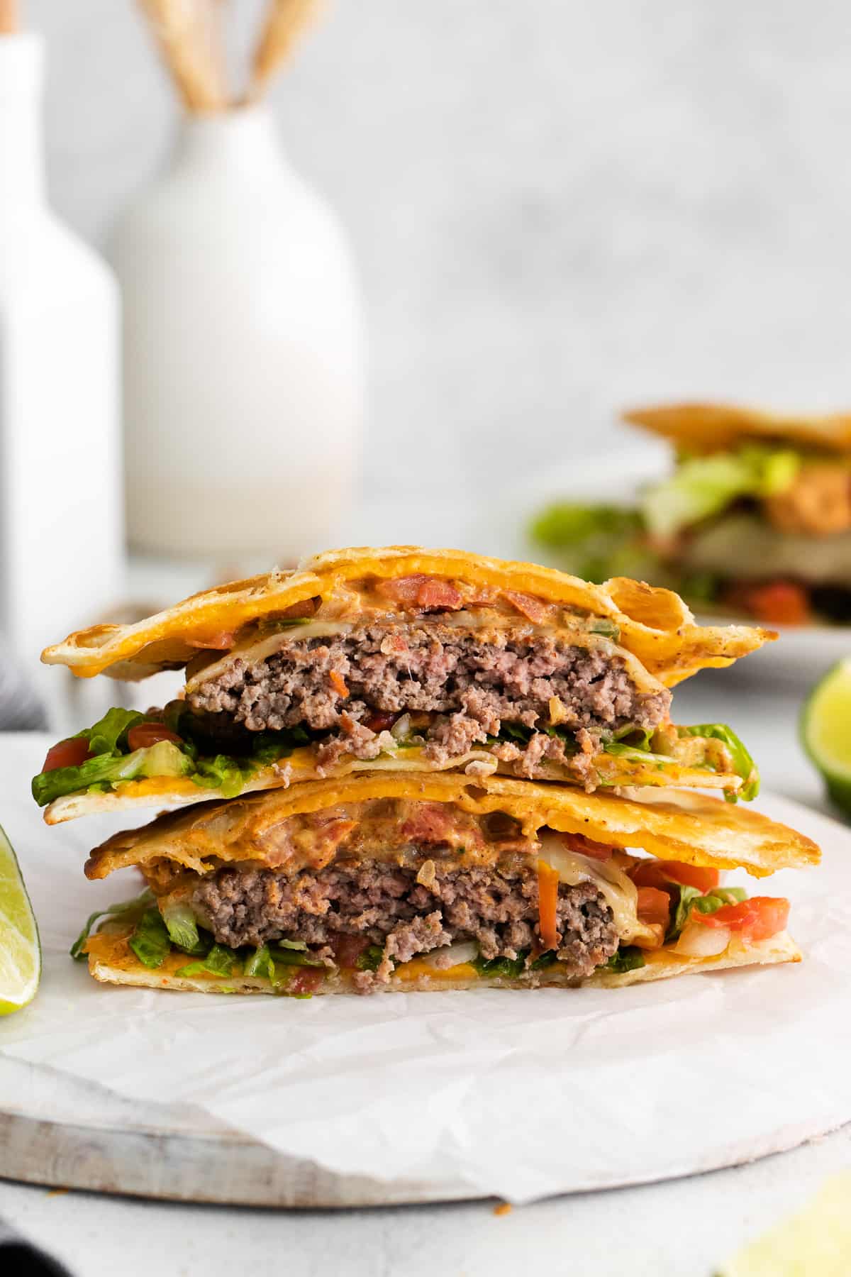Copycat Applebees quesadilla burger stacked on a plate.