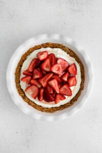 a strawberry cream cheese pie in a white dish.