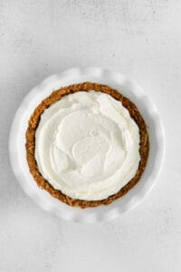 a strawberry cream cheese pie with whipped cream on top.