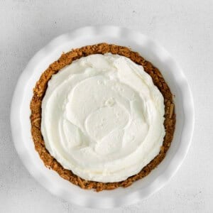 a strawberry cream cheese pie with whipped cream on top.