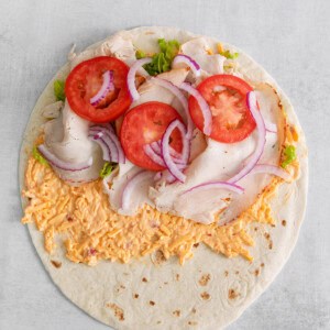 Turkey, onion, and turkey on top of the tortilla.