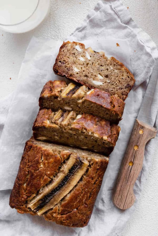 banana bread on countertop with knife.