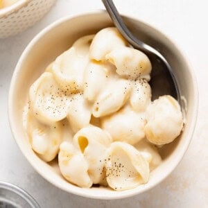 White cheddar mac and cheese served in a bowl with a spoon.