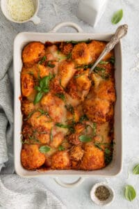a casserole dish filled with meatballs and cheese.