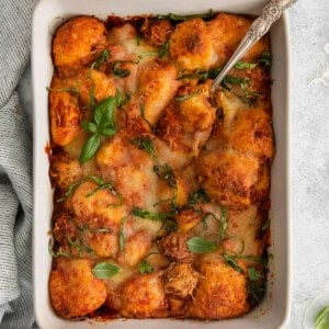 a casserole dish filled with meatballs and cheese.