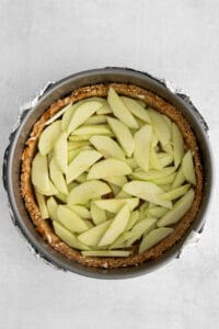 an apple pie is in a metal pan.