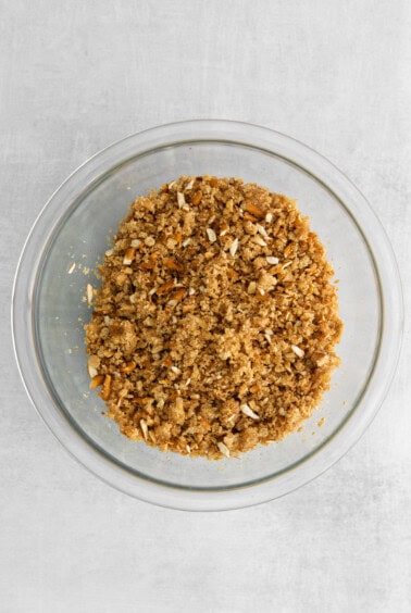 a glass bowl filled with granola on top of a table.