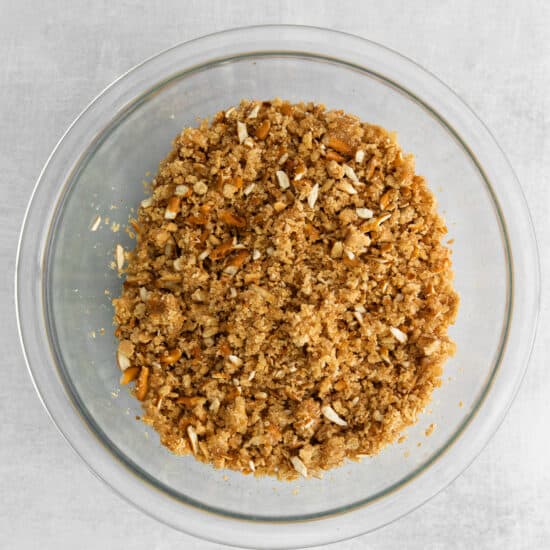 a glass bowl filled with granola on top of a table.