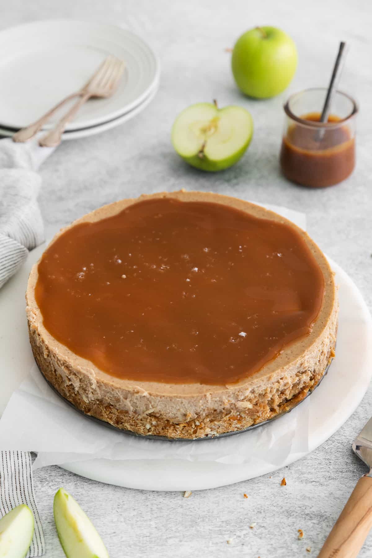 Caramel apple cheesecake topped with caramel sauce and sea salt.