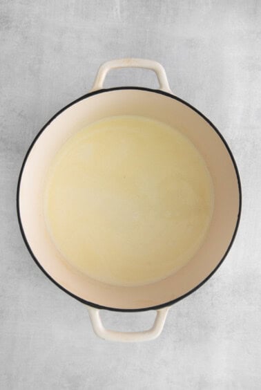 a white pot with a yellow liquid in it.