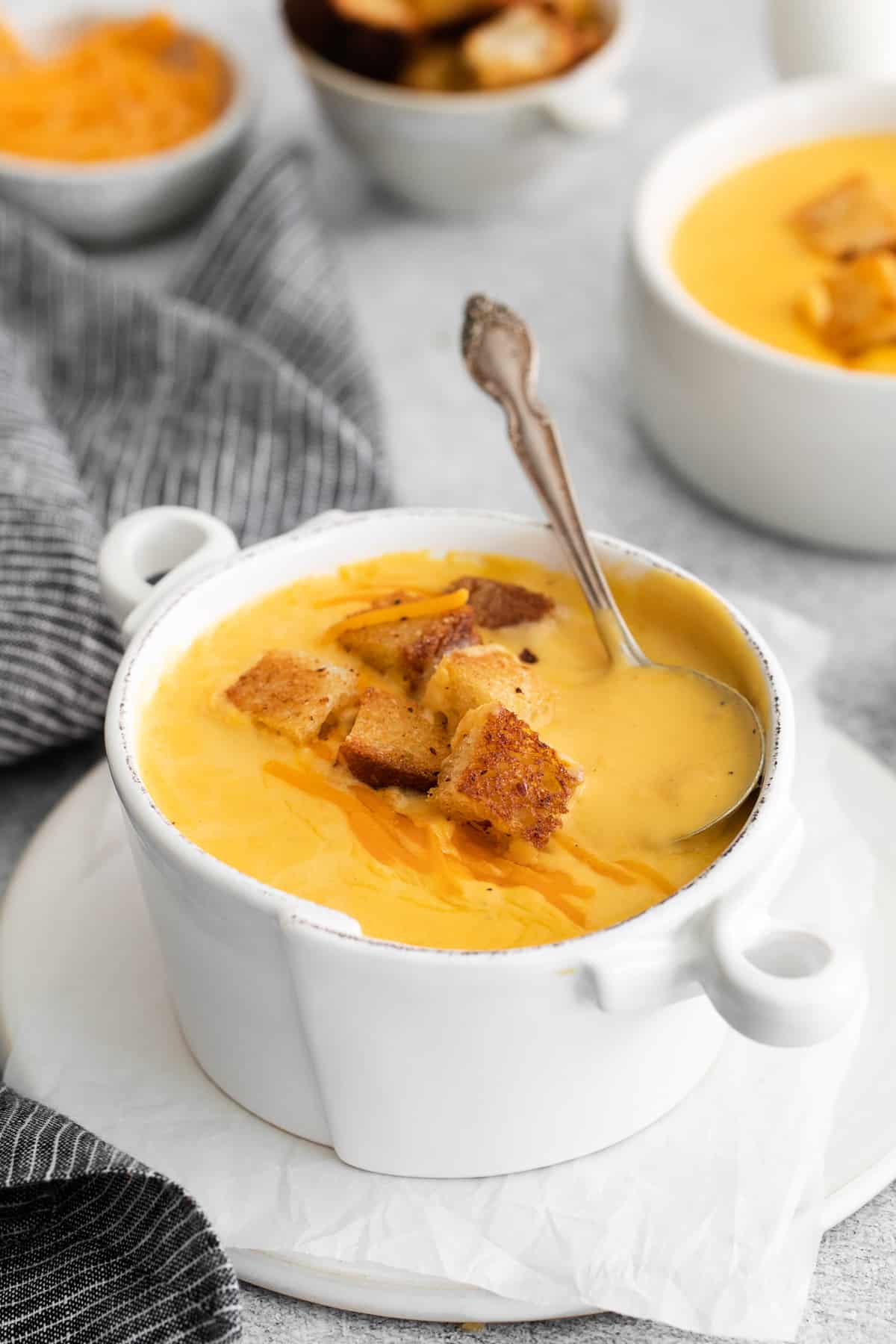 Cheddar cheese soup in a bowl with croutons.