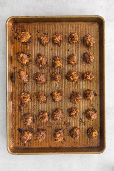 a baking sheet with meatballs on it.