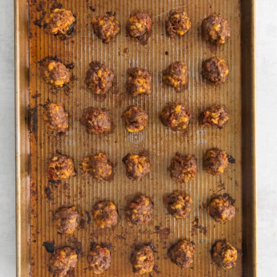 a baking sheet with meatballs on it.