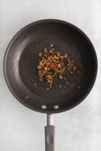 fried nuts in a frying pan on a white background.