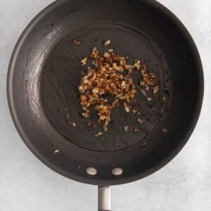 fried nuts in a frying pan on a white background.