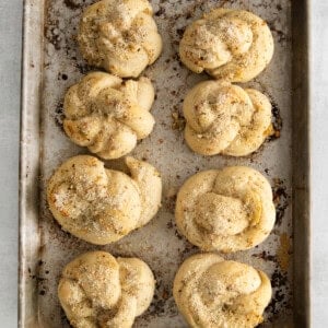 Baked knots with butter brushed over the top.