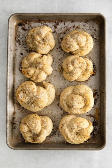 Baked knots with butter brushed over the top.