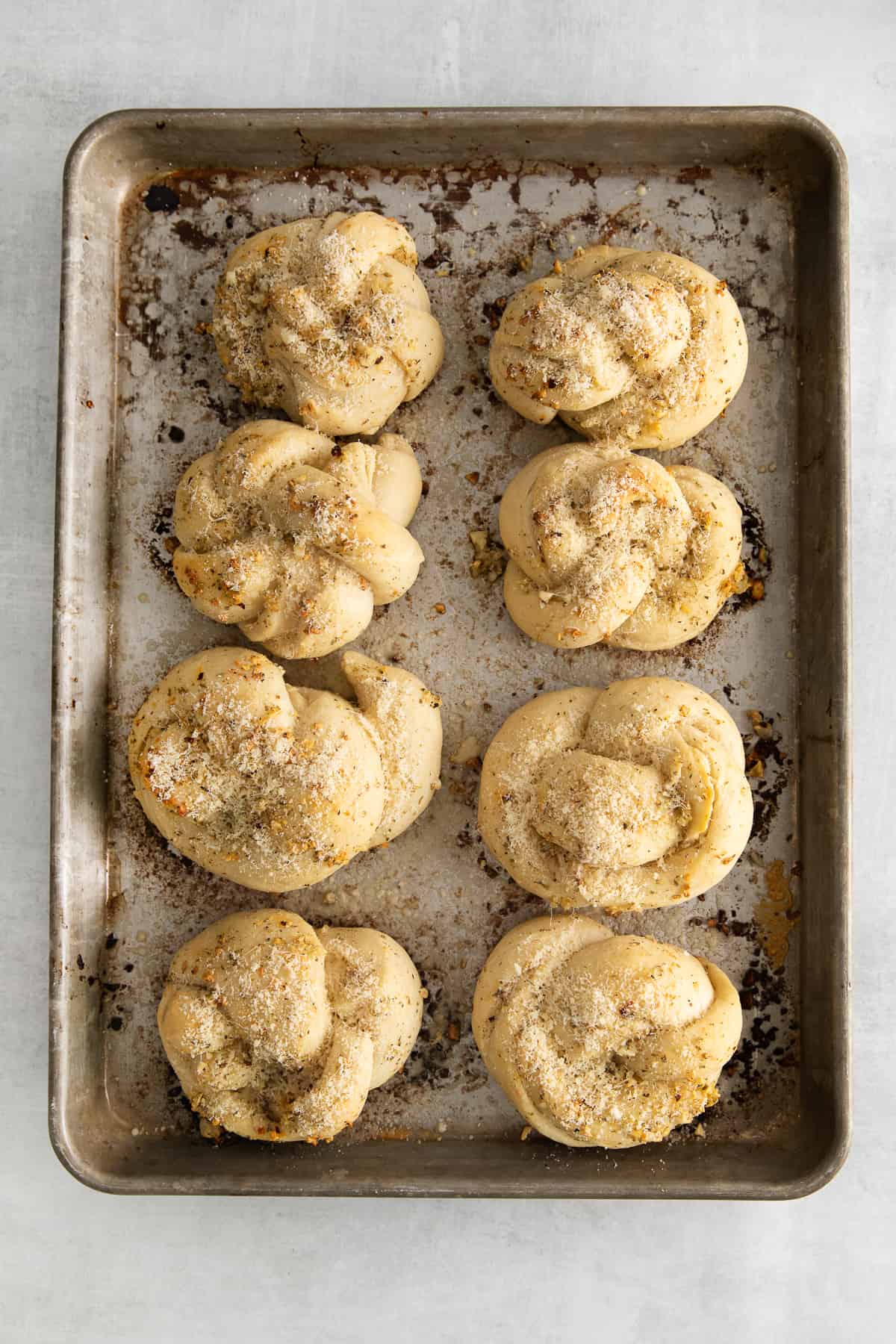 Baked knots with butter brushed over the top.