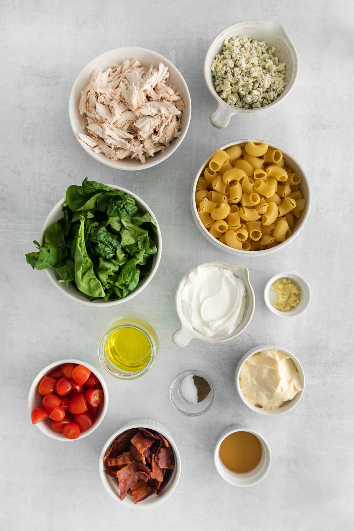 Ingredients for gorgonzola chicken pasta salad in bowls.