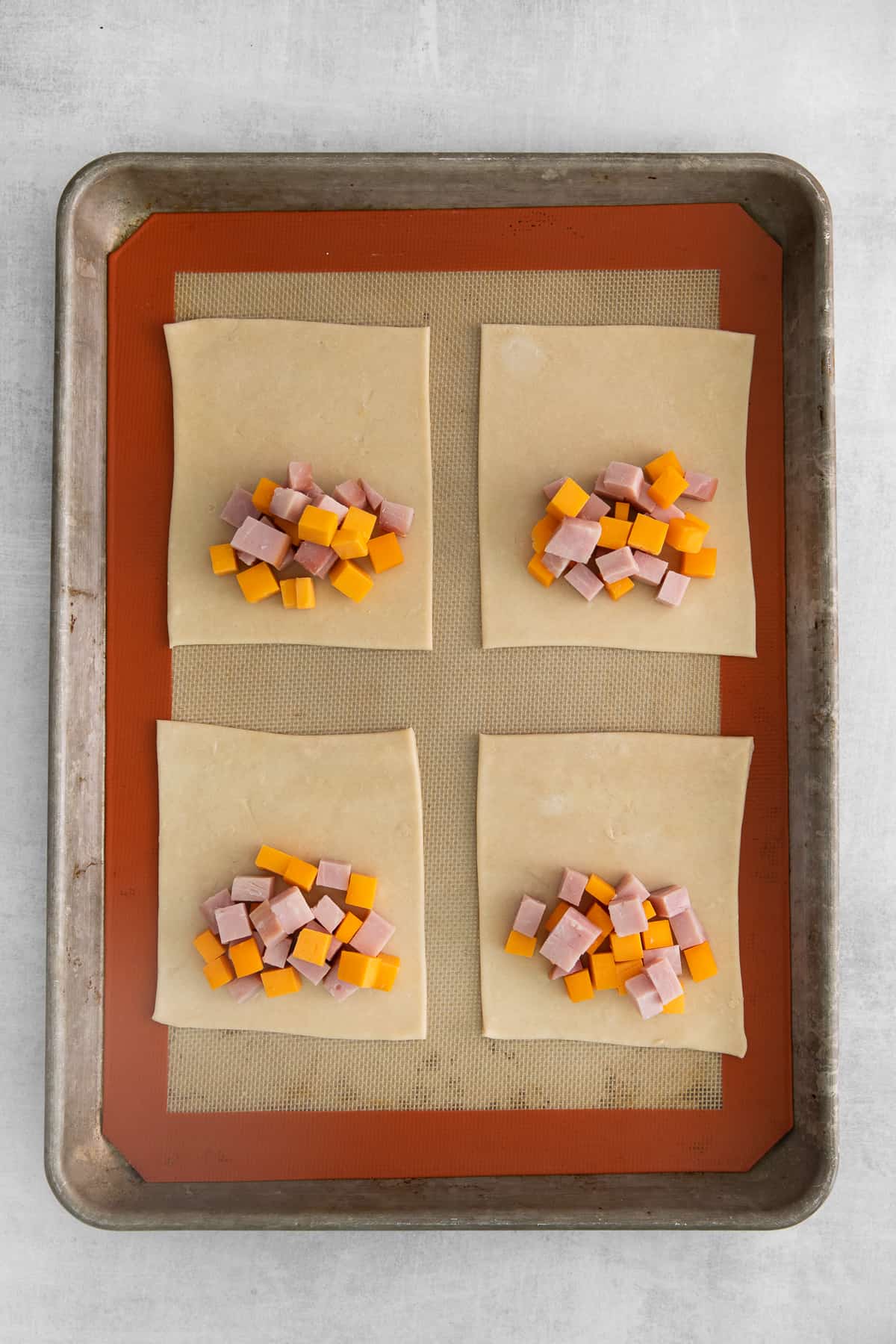 Diced ham and cheese on hand pie dough.