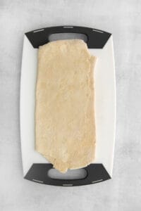 a piece of dough on a cutting board.