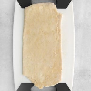 a piece of dough on a cutting board.