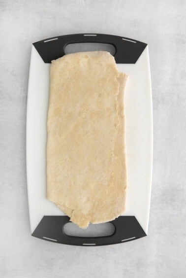 a piece of dough on a cutting board.