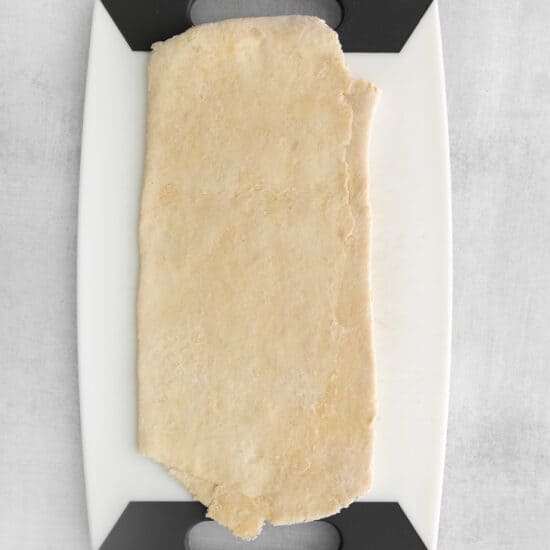 a piece of dough on a cutting board.