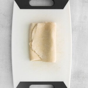 a piece of dough on a cutting board.