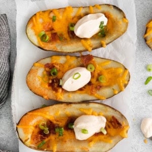 Cheesy potato skins topped with sour cream.