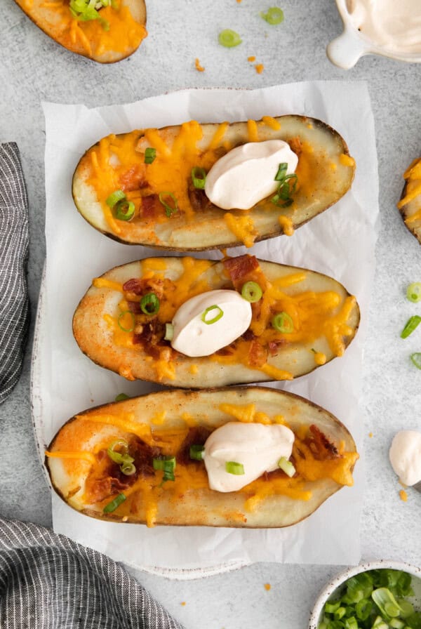 Cheesy potato skins topped with sour cream.