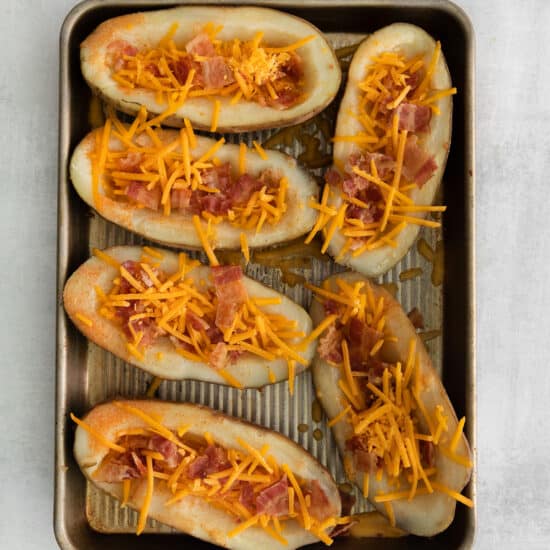 Potato skins with cheddar cheese and bacon.