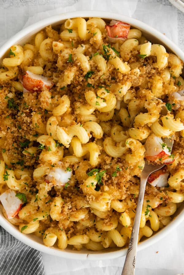 lobster mac and cheese and a spoon in a bowl.