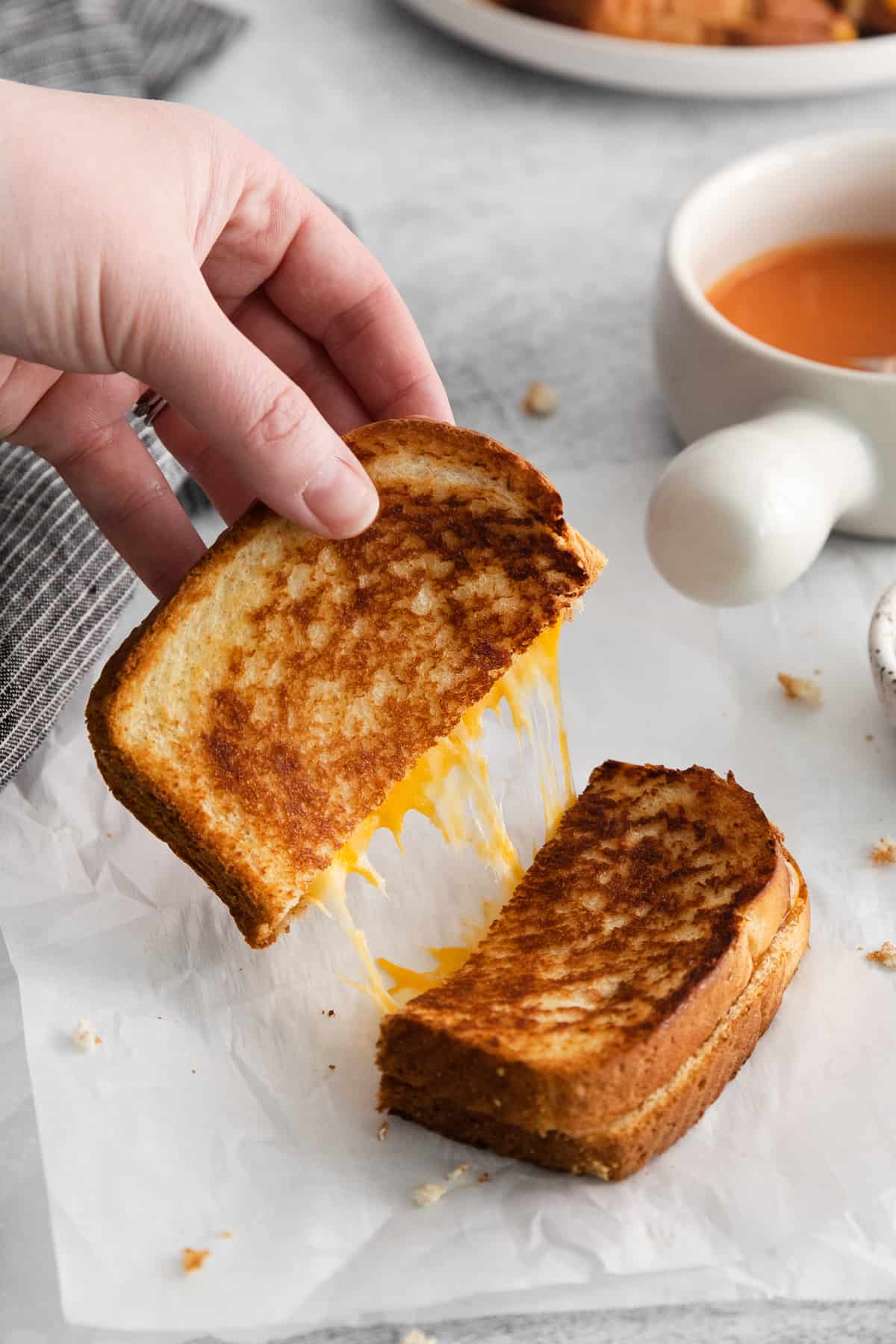 Grilled cheese with mayo sliced in half.