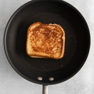 a piece of toasted bread in a frying pan.