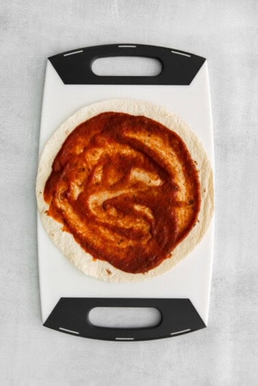 A tortilla with sauce on it.