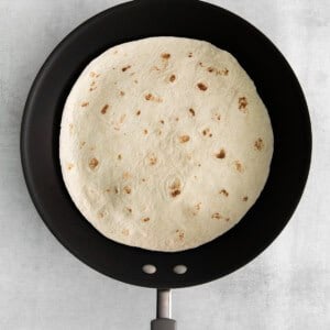 A tortilla in a skillet.