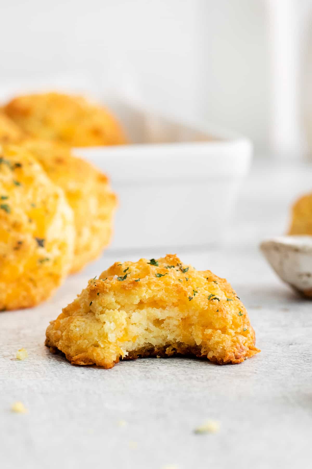 Red lobster cheddar biscuit with a bite taken out of it.